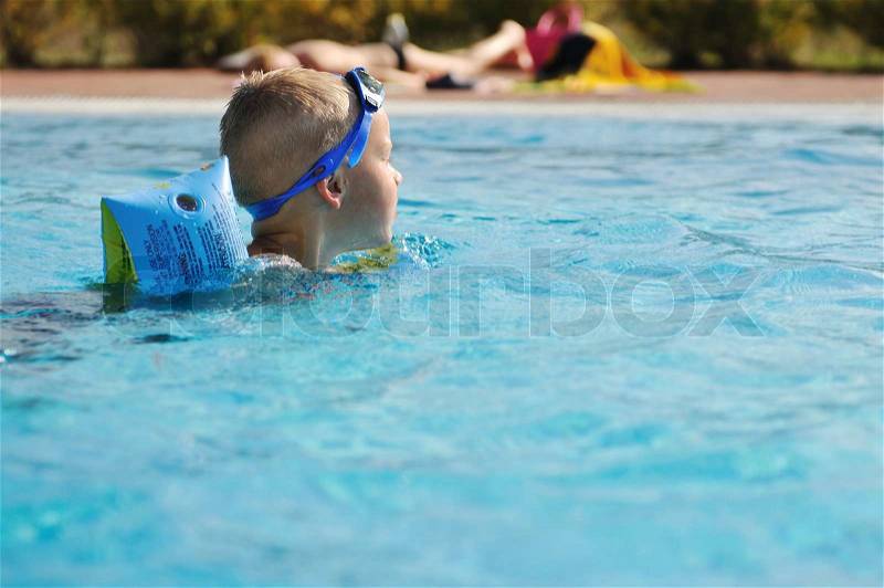 Happy kids have fun on outdoor swimming pool at beautiful aquapark, stock photo