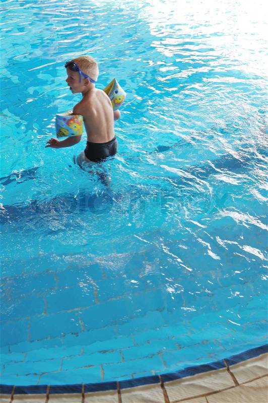 Happy kids have fun on outdoor swimming pool at beautiful aquapark, stock photo