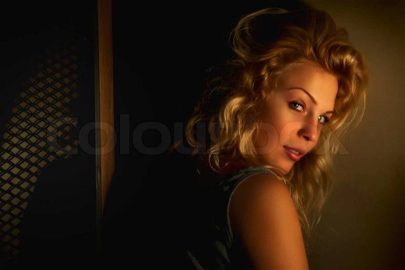 Low key soft focused slightly blurred portrait of young nice woman, stock photo