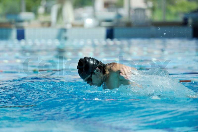 Young healthy with muscular body man swim on swimming pool and representing healthy and recreation concept, stock photo