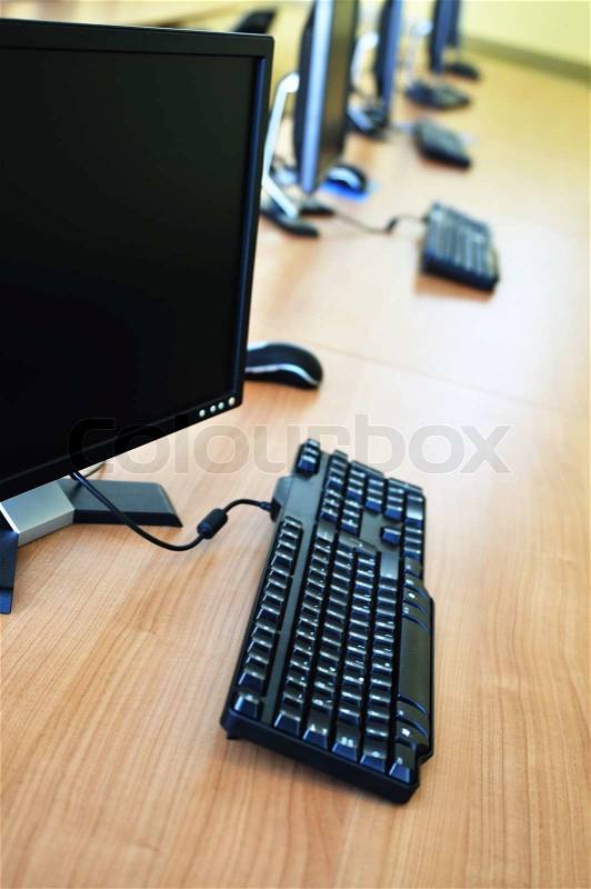Brand new computer with tft monitor in modern classroom at school, stock photo