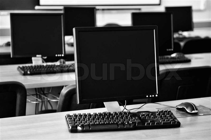 Brand new computer with tft monitor in modern classroom at school, stock photo