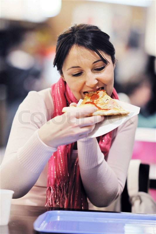 Portrait of young woman eat pizza food at restaurant, stock photo