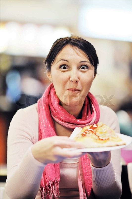 Portrait of young woman eat pizza food at restaurant, stock photo