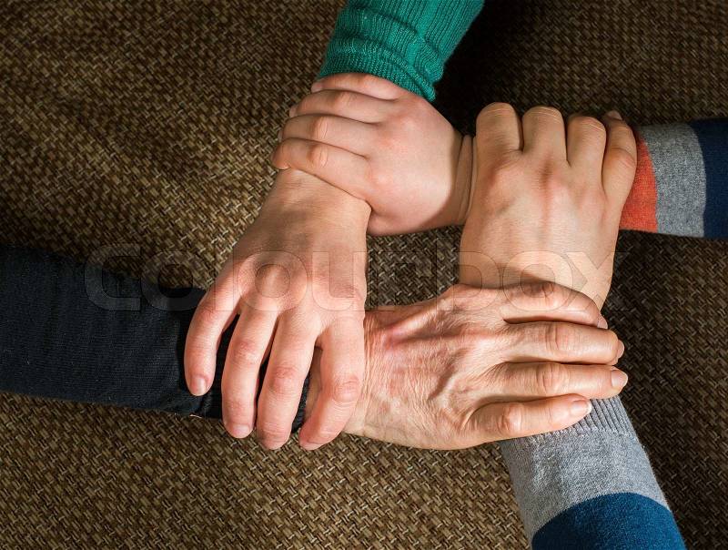 Many hands together. Interior shot, stock photo