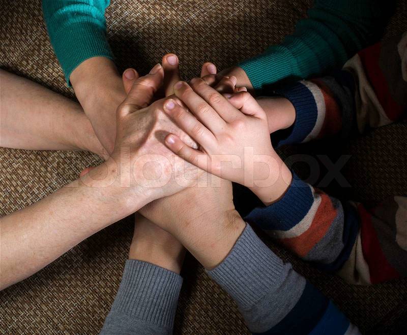 Many hands together. Interior shot, stock photo