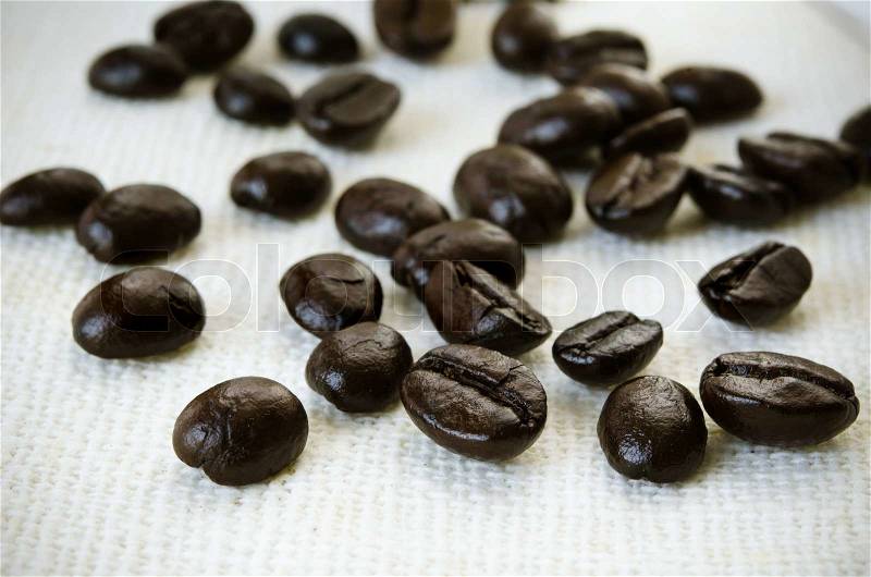 Dried coffee seed on brownish fabric stock photo, stock photo
