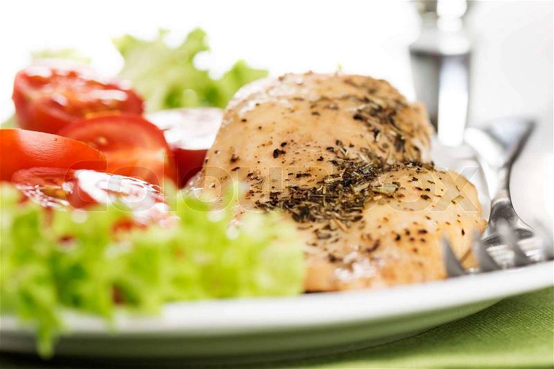 Chicken meet with tomatoes in plate, stock photo