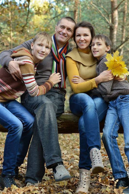 Pretty happy family for a walk in the park fall, stock photo