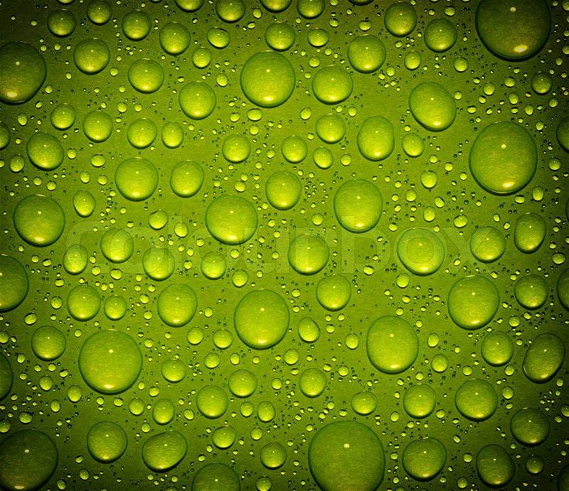 Green water drops on glass , stock photo