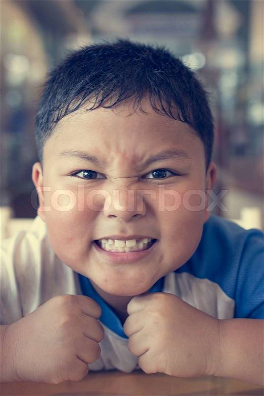 Asia boy making funny faces, stock photo