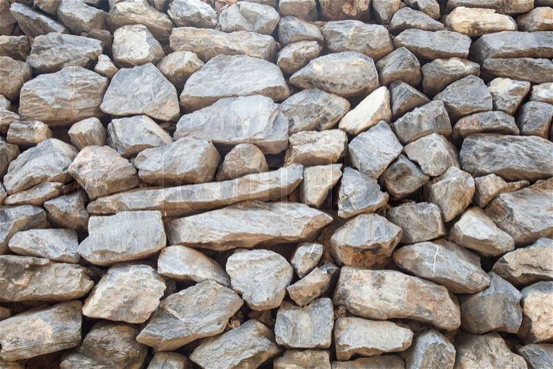 Stones stacked Large rocks stacked a large wall is linear, stock photo