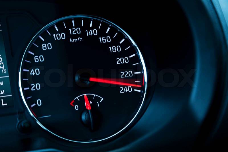 Close-up photo of modern automotive speedometer on black , stock photo