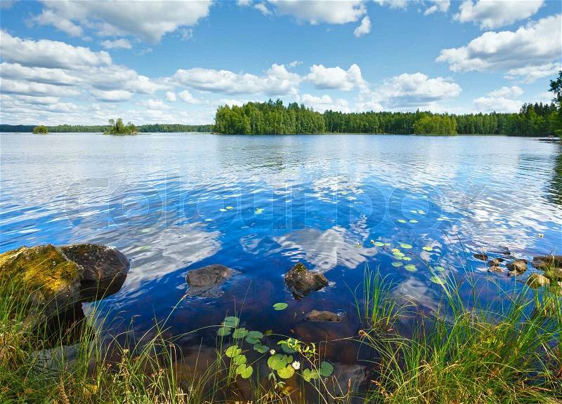 Lake Rutajarvi summer view with reflection of clouds on water surface (Urjala, Finland), stock photo