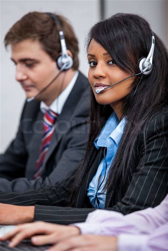 Friendly callcenter agent operator with headset telephone support service , stock photo