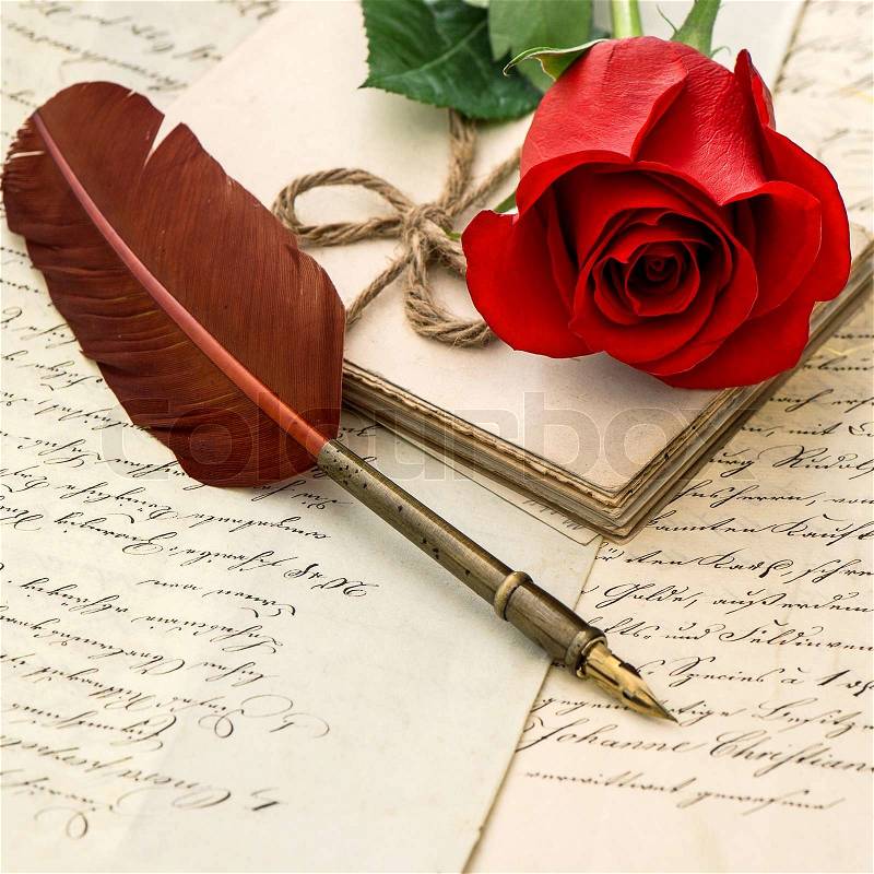 Old love letters, red rose and antique feather pen. selective focus, stock photo