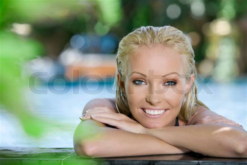 Portrait of young attractive woman having good time swimming pool, stock photo
