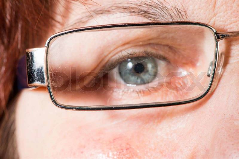 Close up old women blue eye and glasses, stock photo