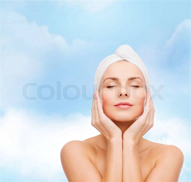 Health, spa and beauty concept - beautiful woman in towel, stock photo