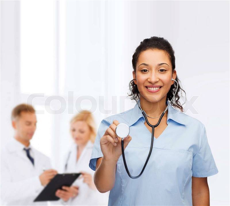 Healthcare and medicine concept - smiling female african american doctor or nurse with stethoscope, stock photo