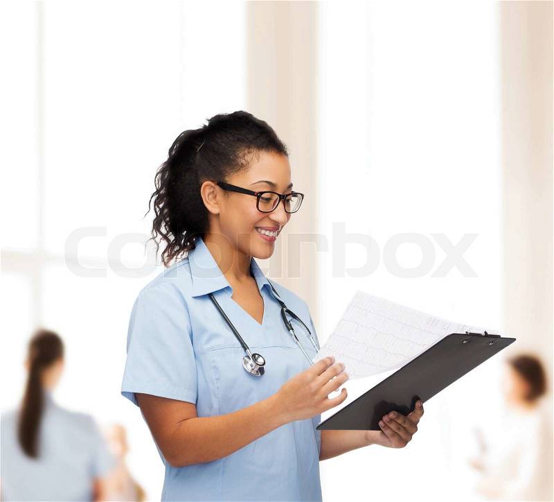 Healthcare and medicine concept - smiling female african american doctor or nurse in eyeglasses with stethoscope and clipboard, stock photo