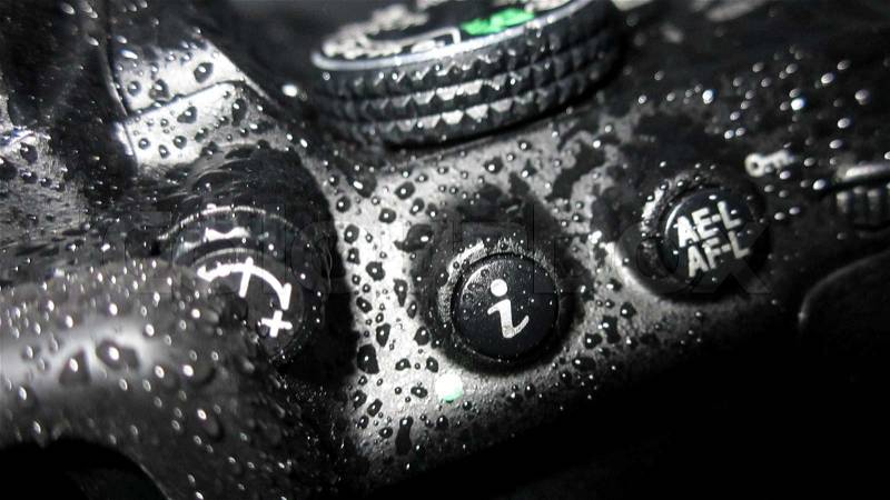 Close up of wet camera. The camera is a Nikon d5300, stock photo