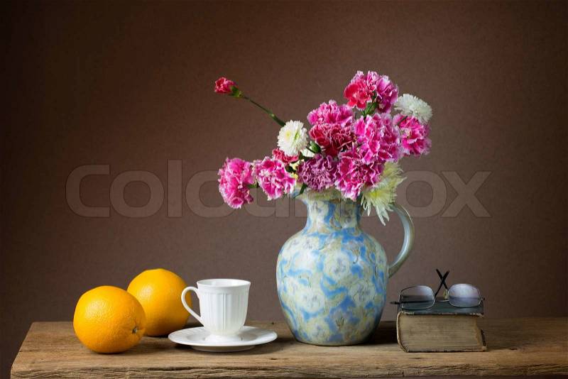 Still life with bunch of flowers and oranges, stock photo
