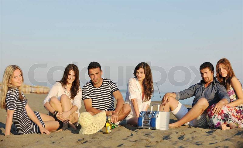 Happy young people group have fun run and jump on beach beautiful sand beach, stock photo