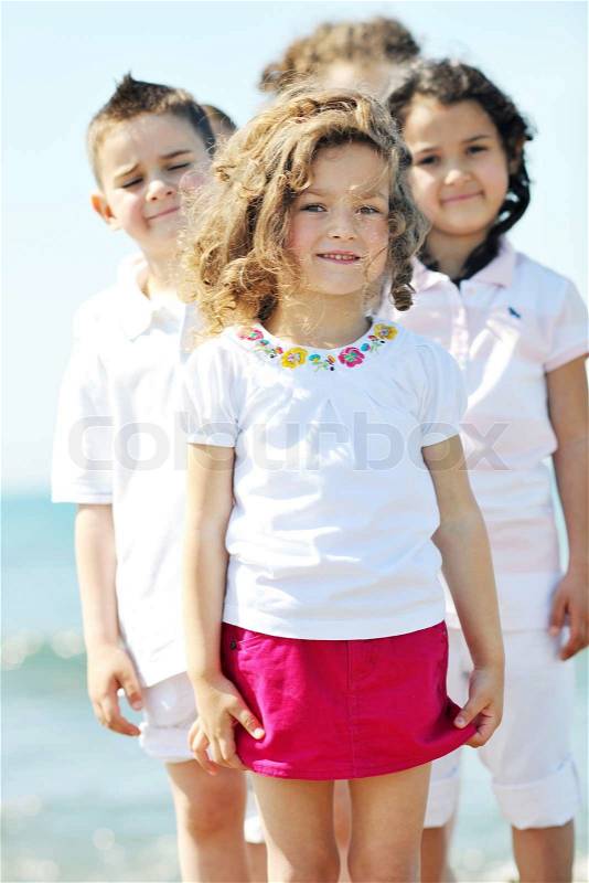 Group of happy child on beach who have fun and play games, stock photo