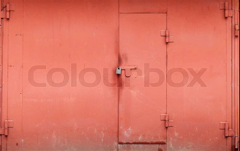 Red metal garage wall with locked gate. Background texture, stock photo