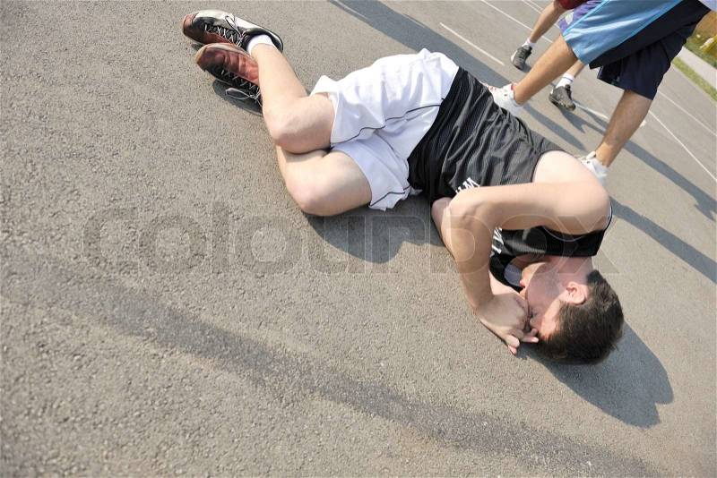 Basketball player have foot trauma strech and injury at outdoor streetbal court, stock photo