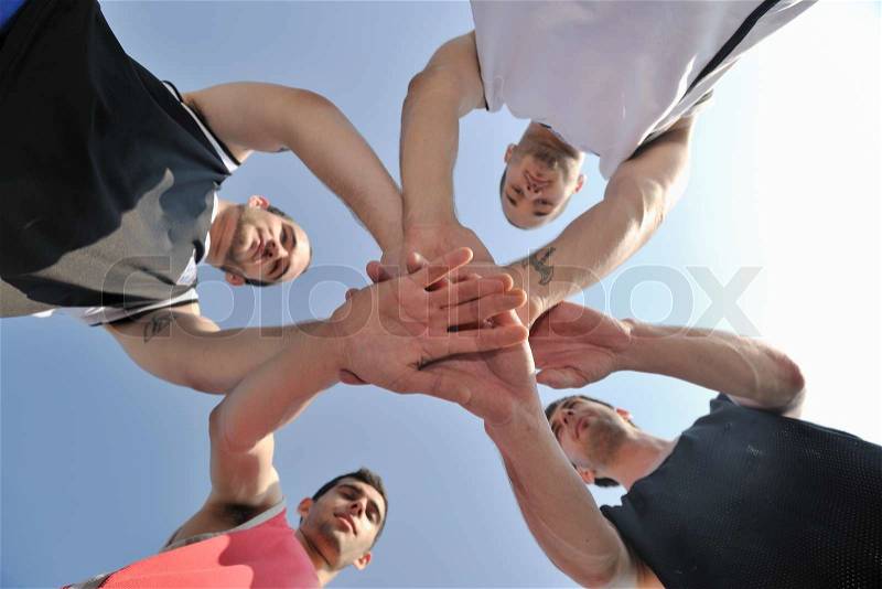 Basketball player team group posing on streetbal court at the city on early morning, stock photo