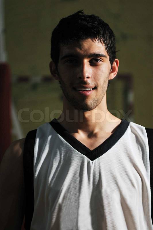 One basket ball game player standing in sport gym with ball, stock photo