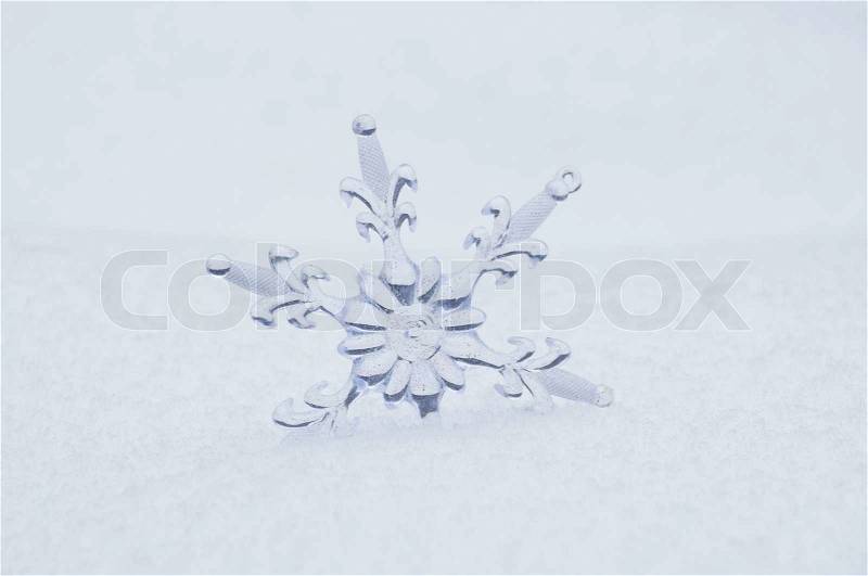 Snowflake in a white snow, stock photo