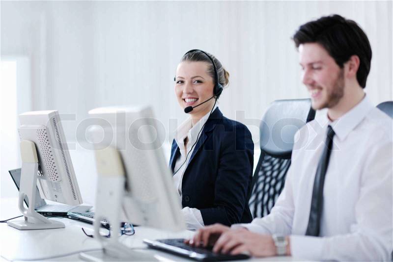 Business people group with headphones giving support in help desk office to customers, manager giving training and education instructions, stock photo