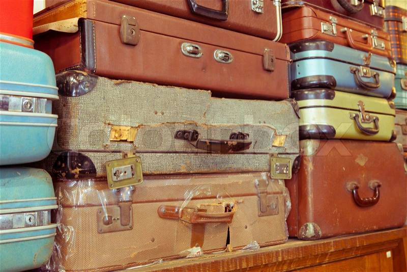 Vintage old battered leather suitcases stacked, stock photo