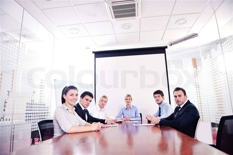 Group of happy young business people in a meeting at office, stock photo