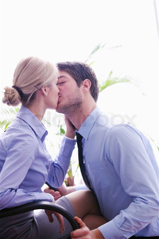 Business people in love have romantic time at workplace, stock photo