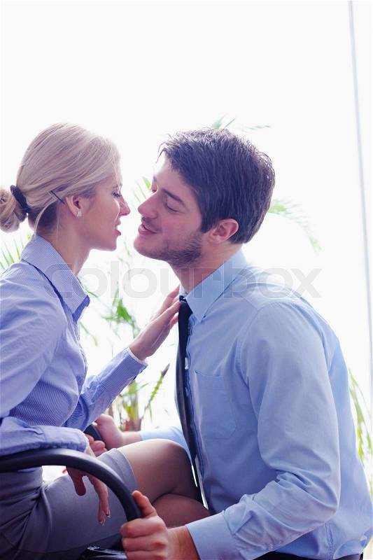Business people in love have romantic time at workplace, stock photo