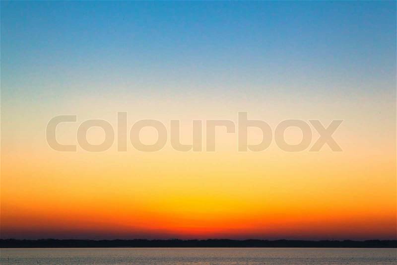 Orange sunset gradation under the blue sky, stock photo
