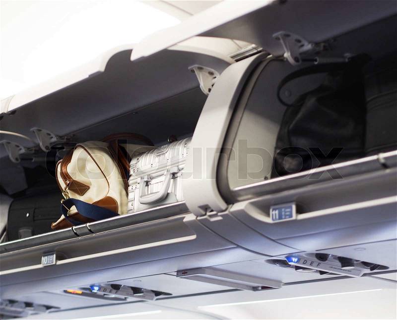 Hand luggage compartments on a jet plane, stock photo