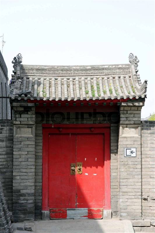 Typical Chinese historic building with a red door, stock photo