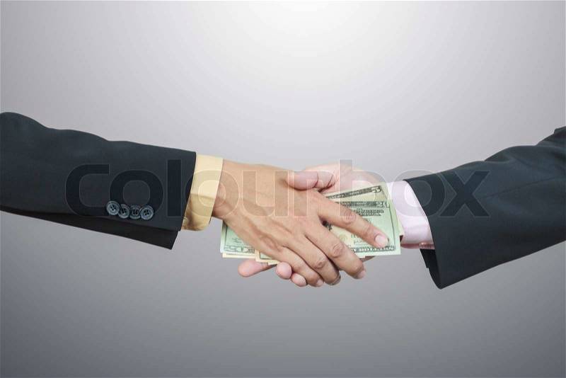 Businessman hand and money to other for corruption concept, stock photo