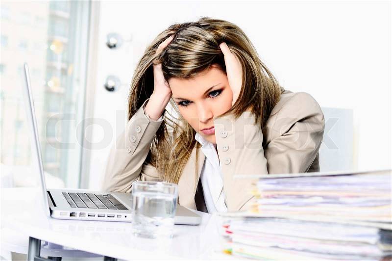 Stressed woman working on computer, stock photo