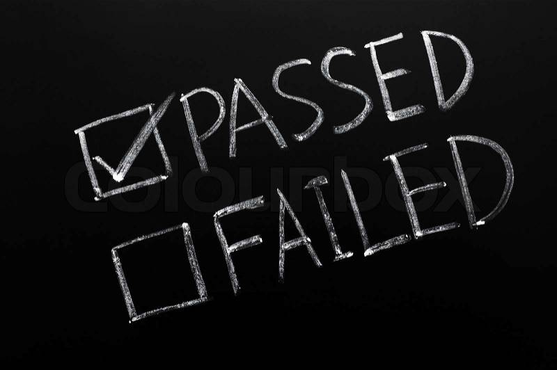 Check boxes of passed and failed with passed checked on a blackboard, stock photo