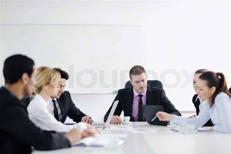 Business people team at a meeting in a light and modern office environment, stock photo