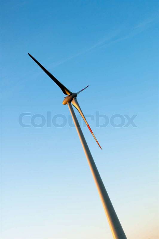 Profil of a Electric wind turbines on sunset background, stock photo