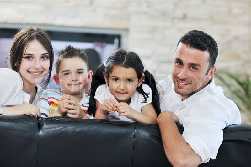 Happy young family relax and have fun at modern home indooor, stock photo