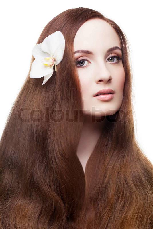 Portrait of beautiful girl with white orchid in her long hair, stock photo