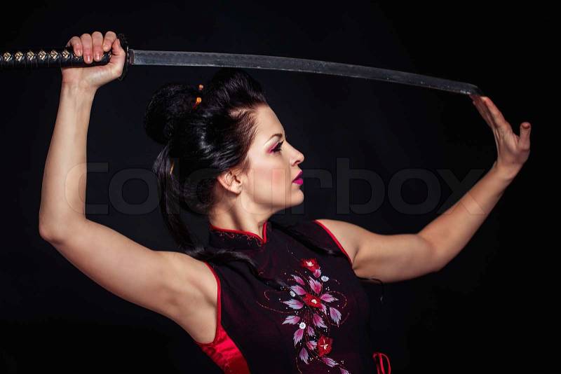 Woman with japan sword katana in hands, stock photo